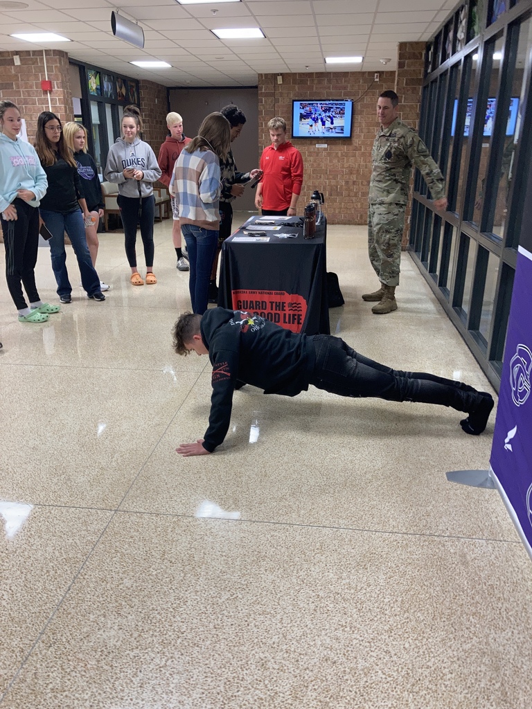 Hayden doing push - ups students looking on