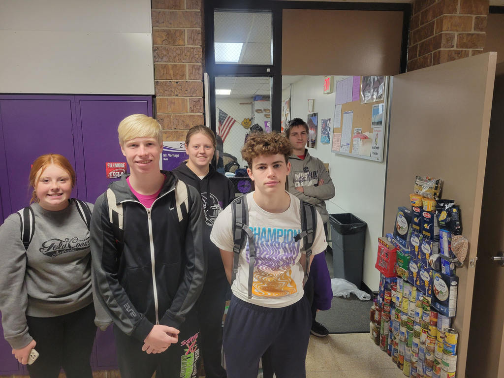 Students from Mr. Verhage's homeroom posing with their food drive donation at the stack the door competition. 