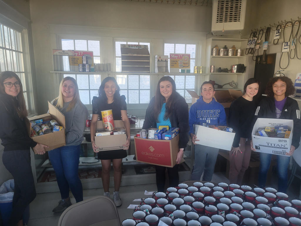 FBLA members donating food from their food drive to the Christmas store. 
